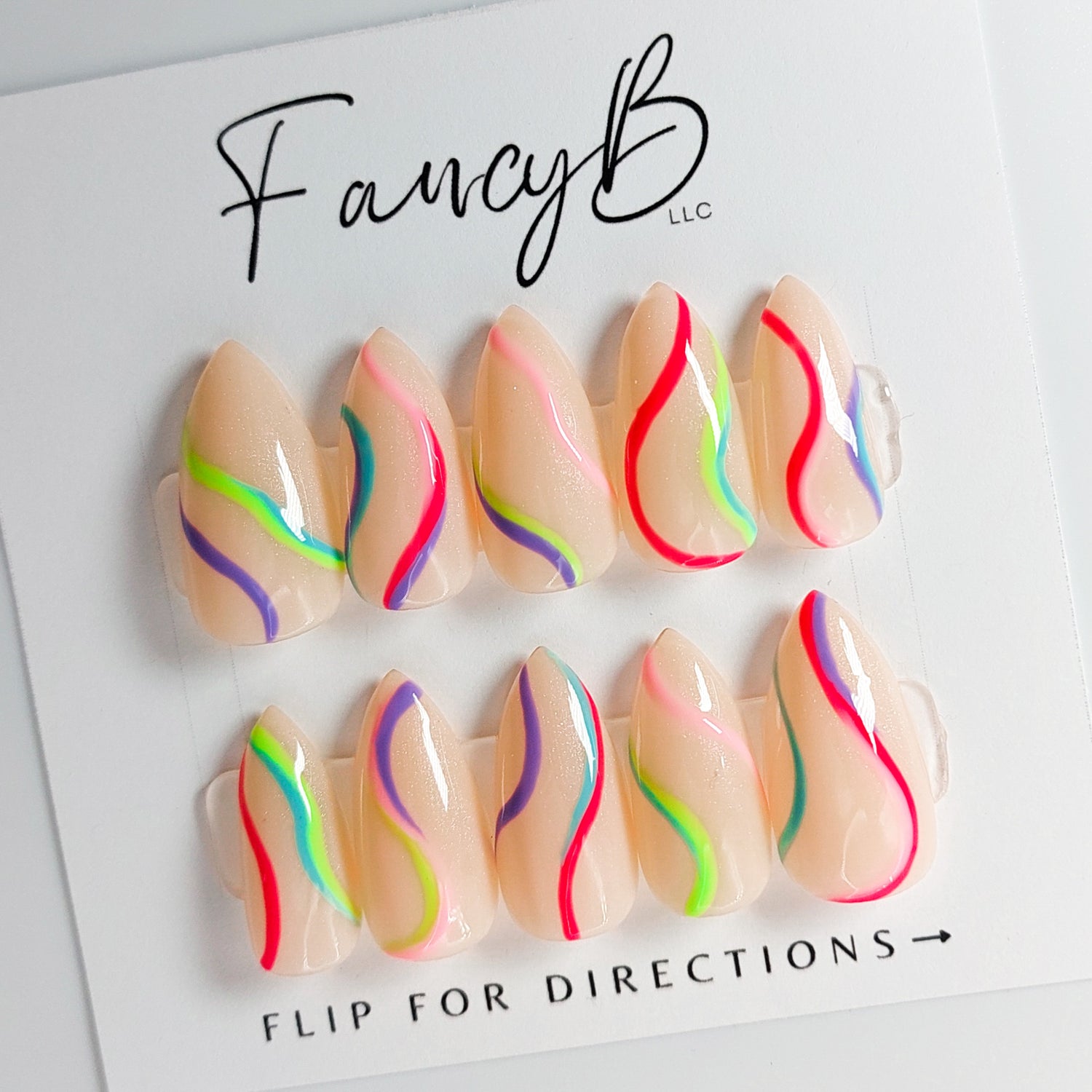 Custom press on nails. Nude press on nails with rainbow swirls in sharp short stiletto shape.