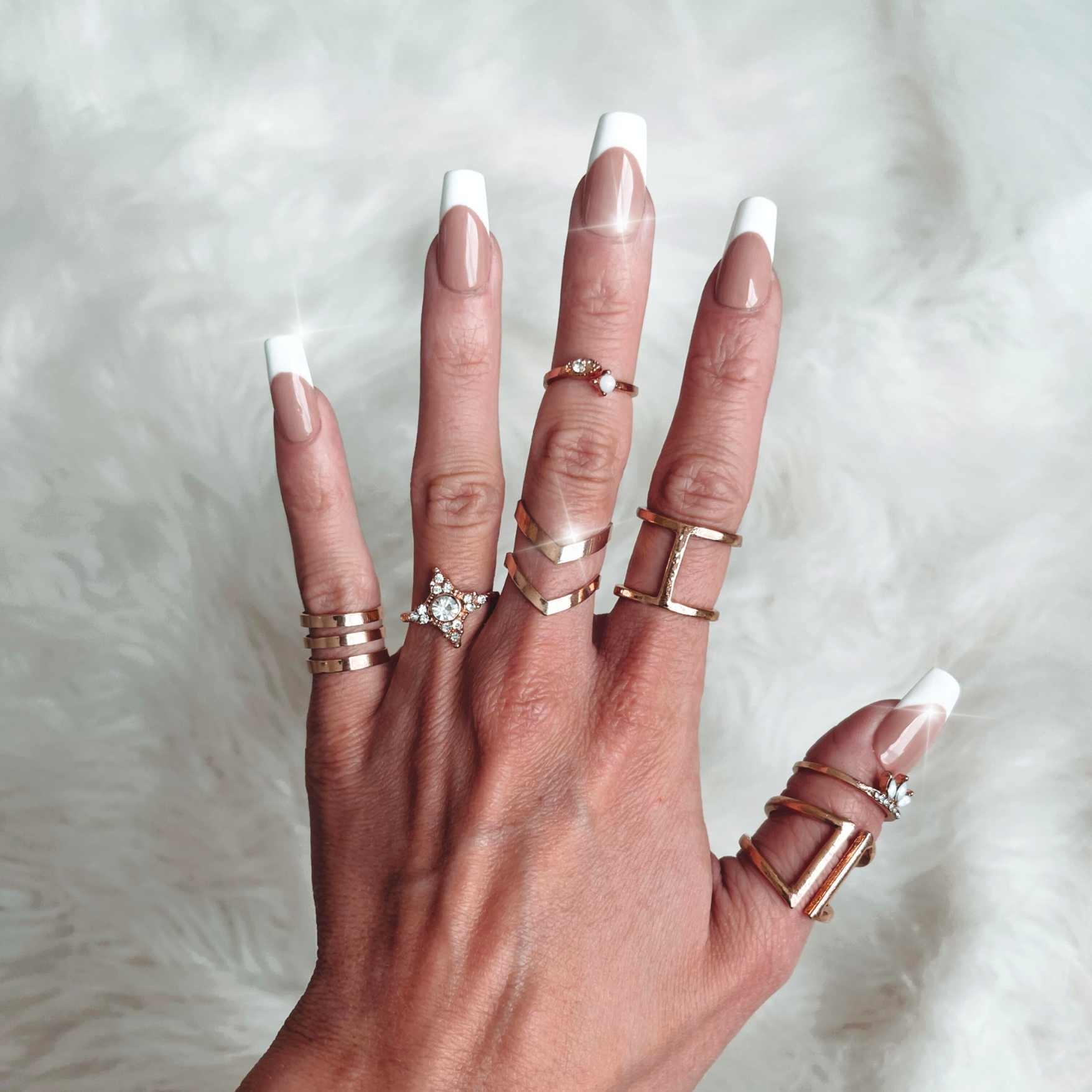 Reusable, handmade press on nails in a beautiful standard french design with a soft nude base. shown in extra short coffin by hannalee marie.