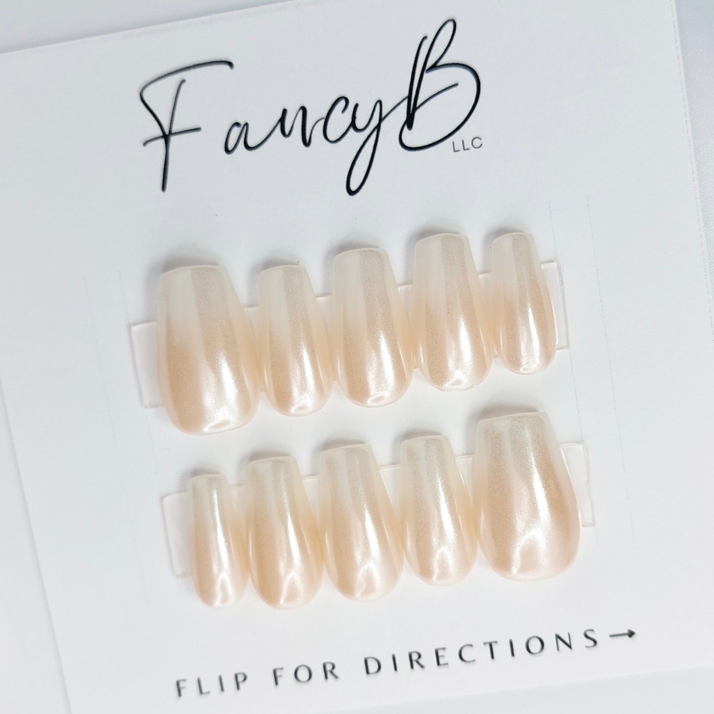 hailey b ombre press on nails, chrome glaze nails in nude to white. Short coffin.