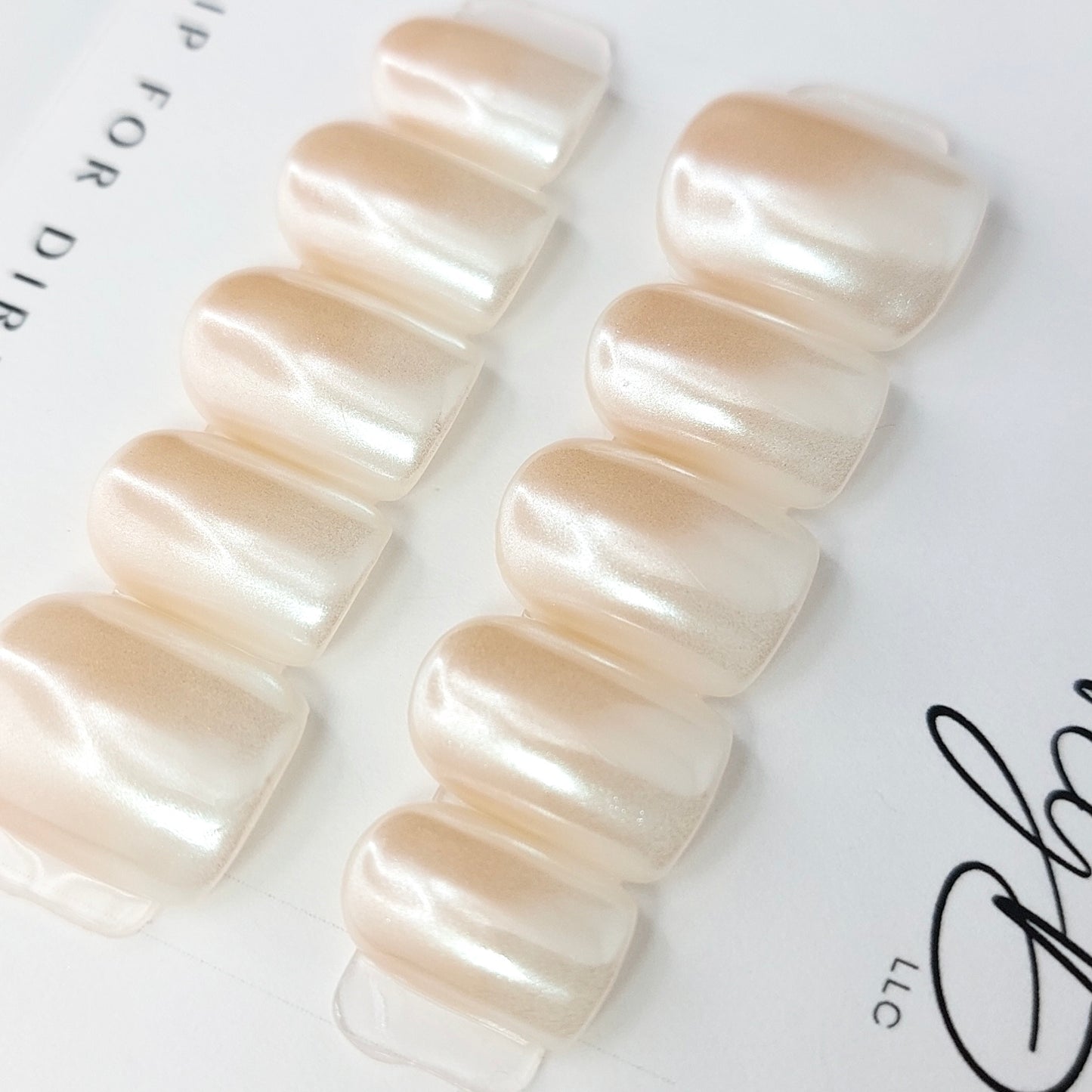 hailey b ombre press on nails, chrome glaze nails in nude to white.
