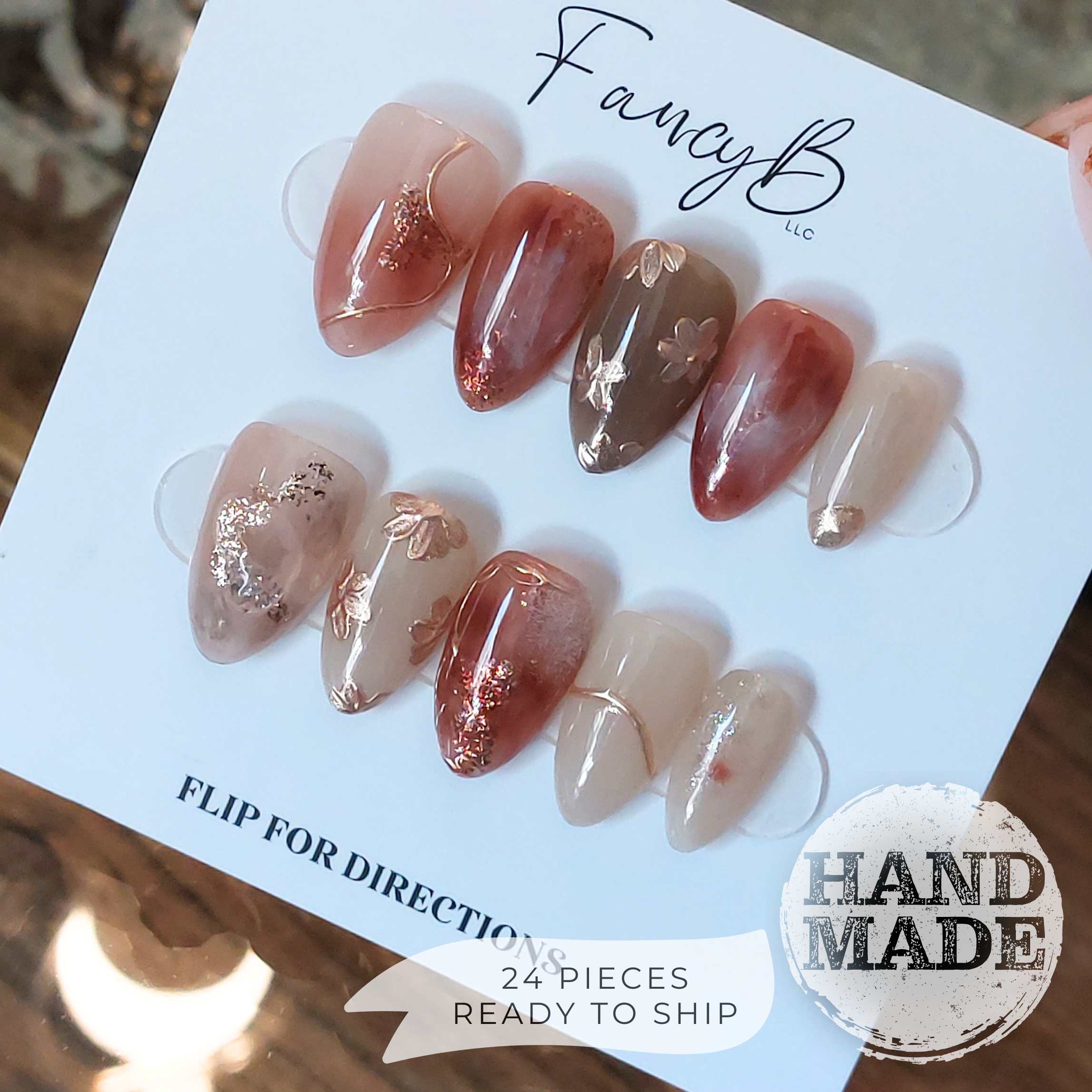 Fancy Floral press on nails, flower press on nails with gold and champagne flowers, pink merlot marble designs with glitter and champagne accents. Handmade reusable press on nails from FancyB Nails in short almond.