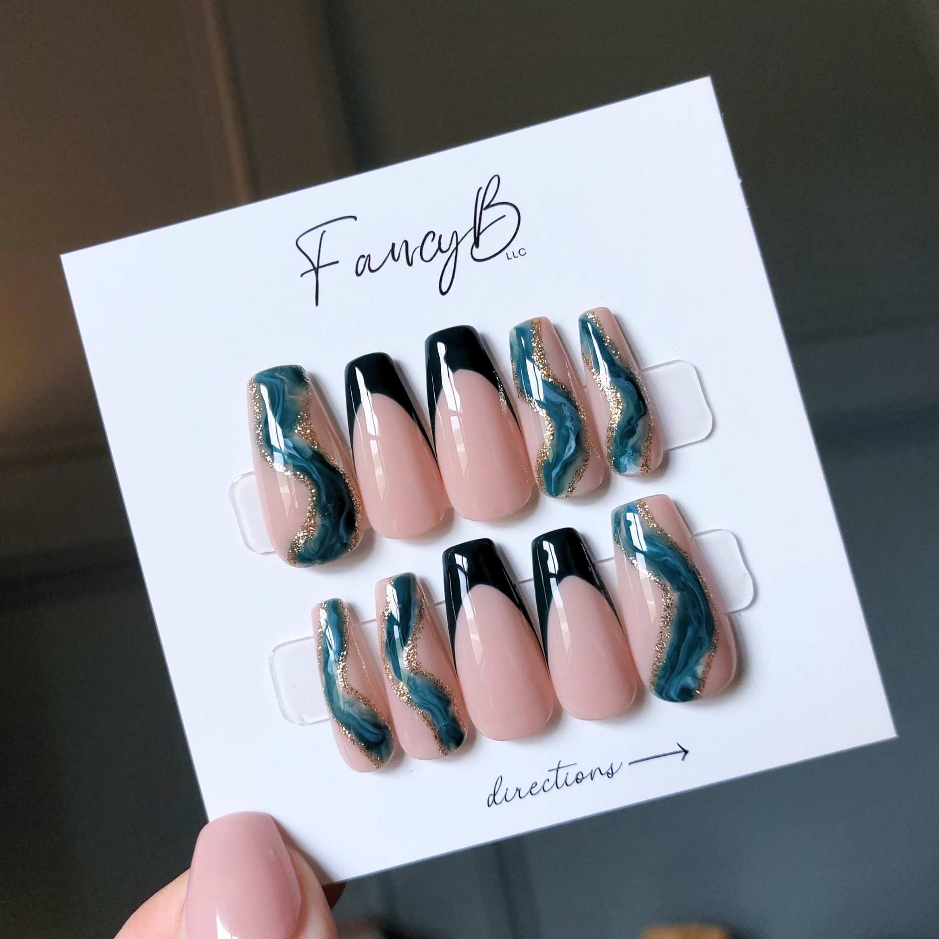 Custom marble nails with teal designs and teal french accents with gold glitter on medium coffin nails from fancyb nails