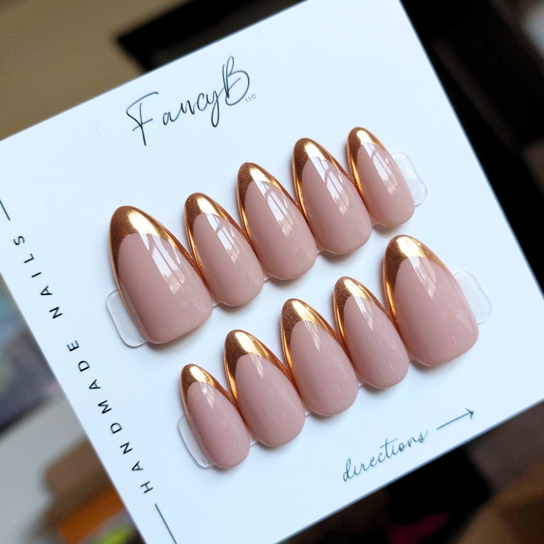 custom chrome french nails with gold chrome french tips on nude base color on a medium almond nail shape from fancyb press on nails