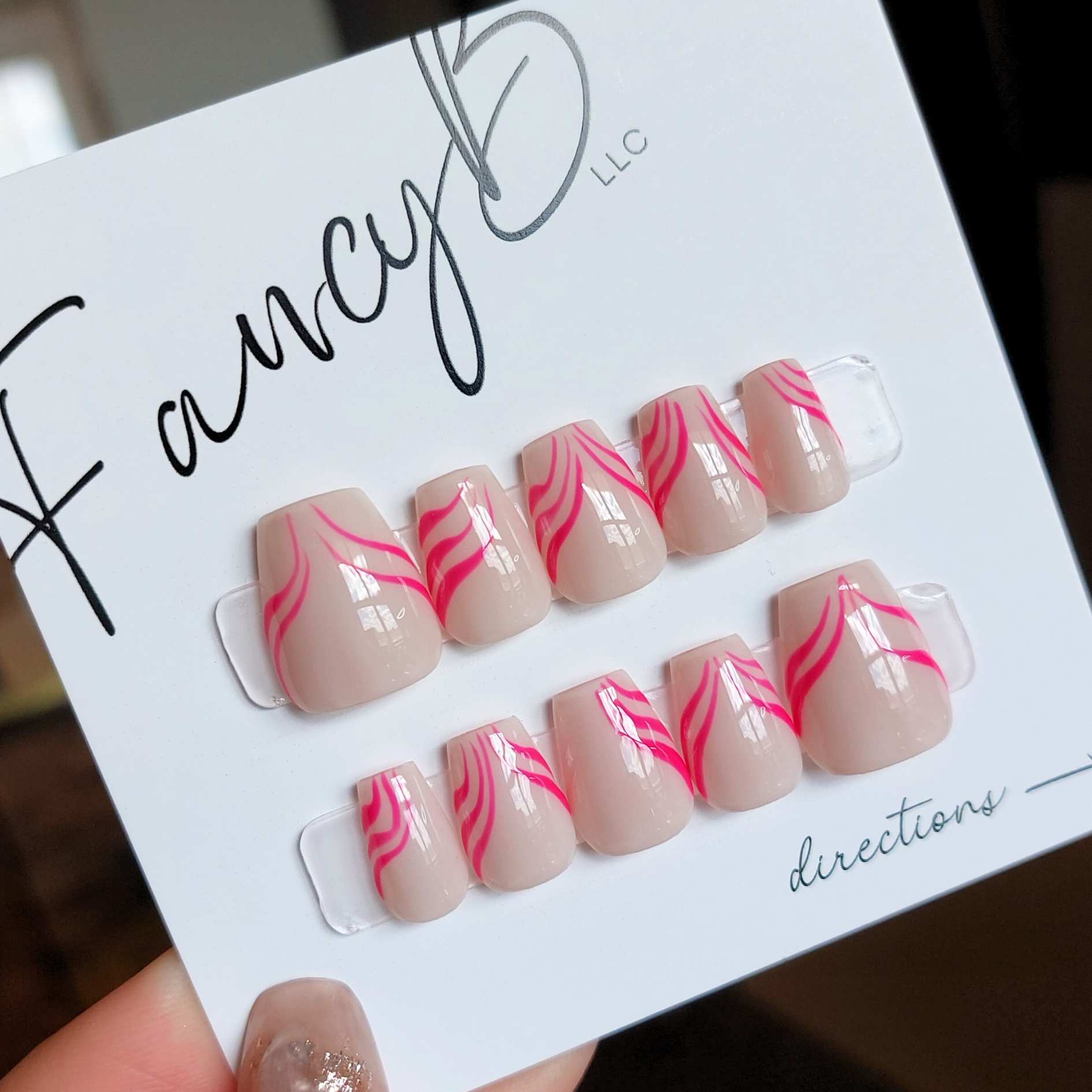 custom pink stripe nails, press on nails with nude color and hot neon pink curvy stripes on extra short coffin nails from fancyb press on nails