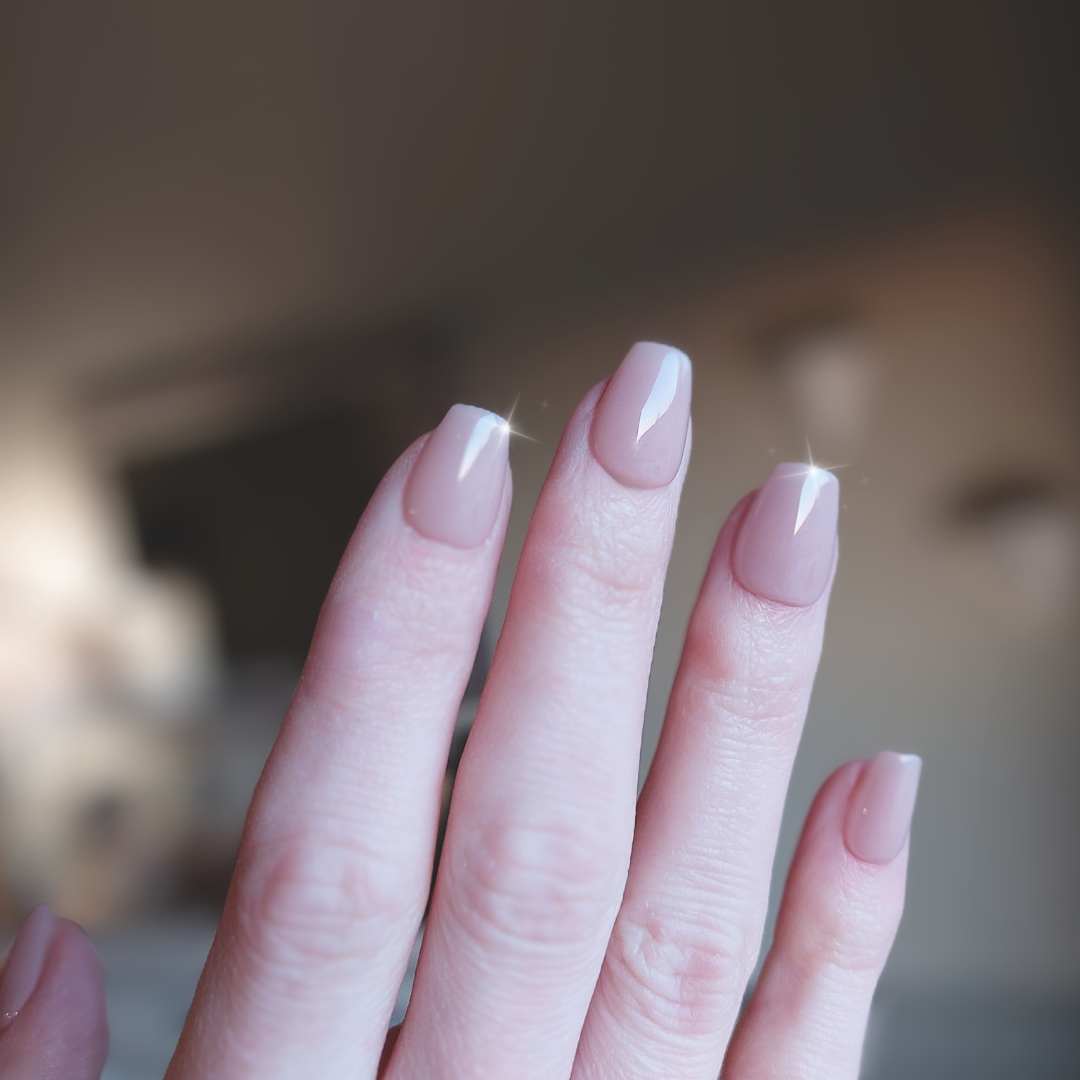 Jelly nude nails in extra short coffin shape, perfectly natural nude color with a milky texture finish from fancyb nails.