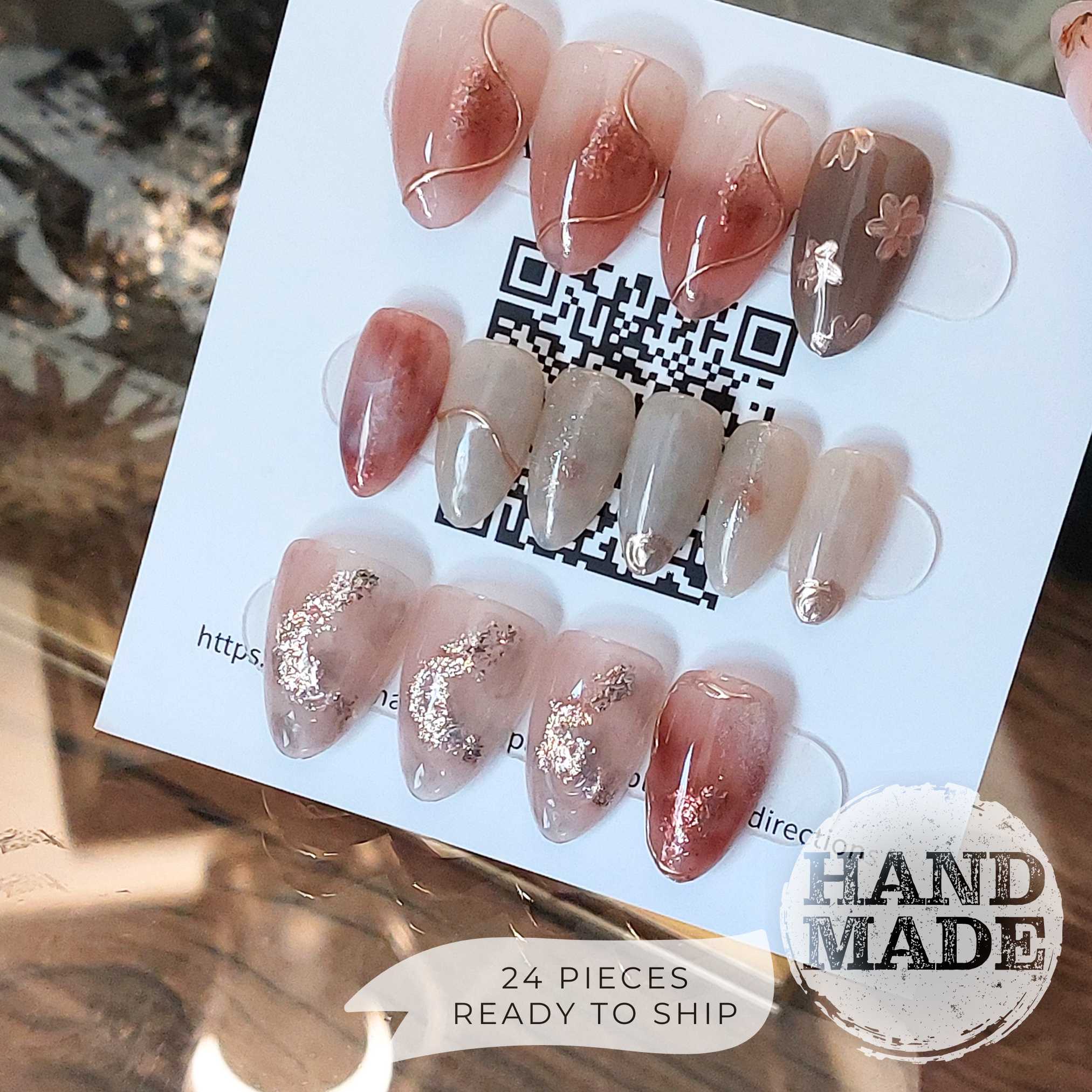 Fancy Floral press on nails, flower press on nails with gold and champagne flowers, pink merlot marble designs with glitter and champagne accents. Handmade reusable press on nails from FancyB Nails in short almond.