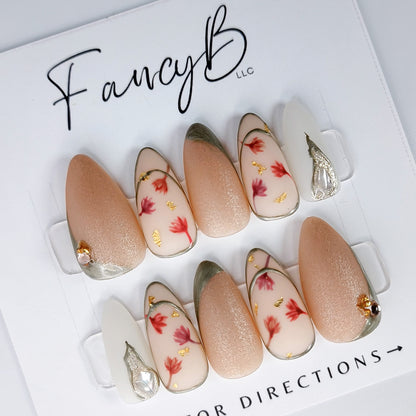 Custom press on nails, japanese floral art with light pink and nude colors, watercolor flower designs, matte finish, gold metallic accents and rose gold gems. FancyB Nails.