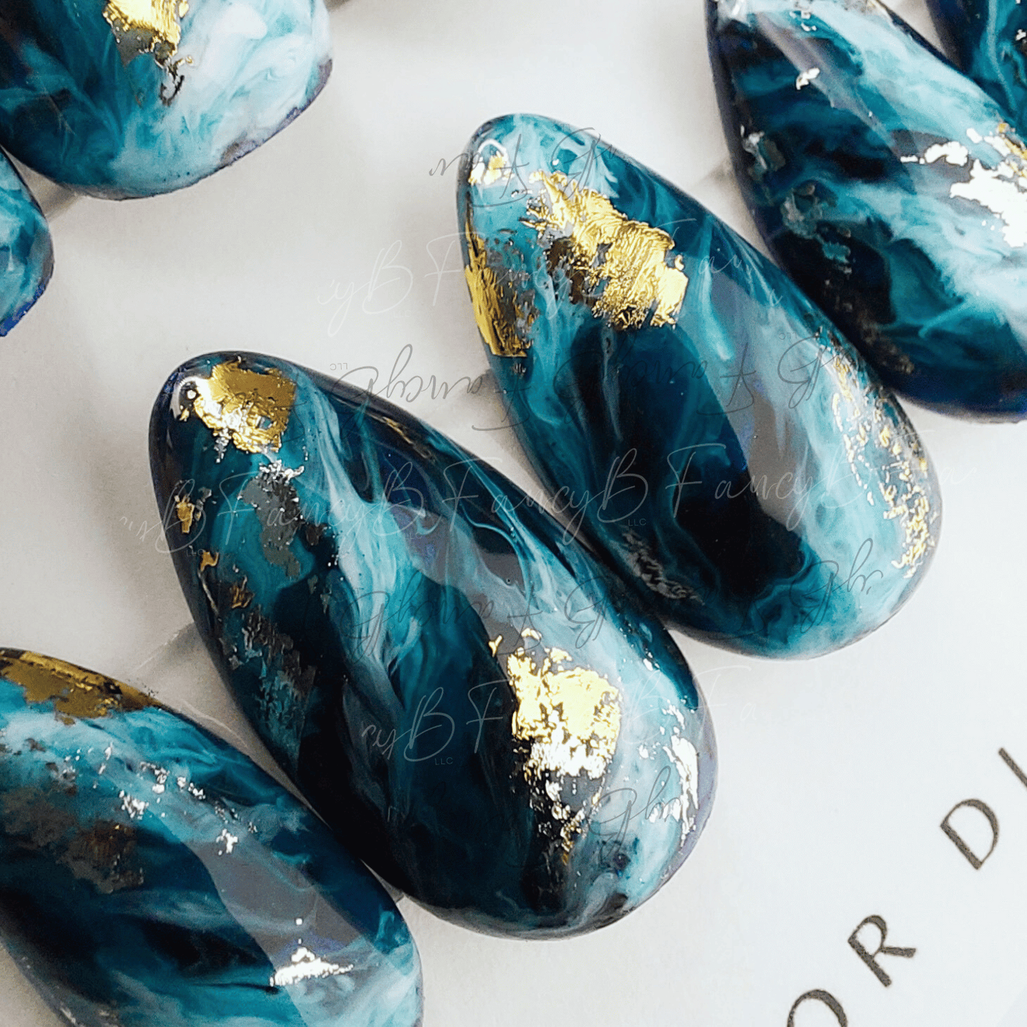 Blue ocean marble press on nails with gold flakes. FancyB Nails custom press on nail design.