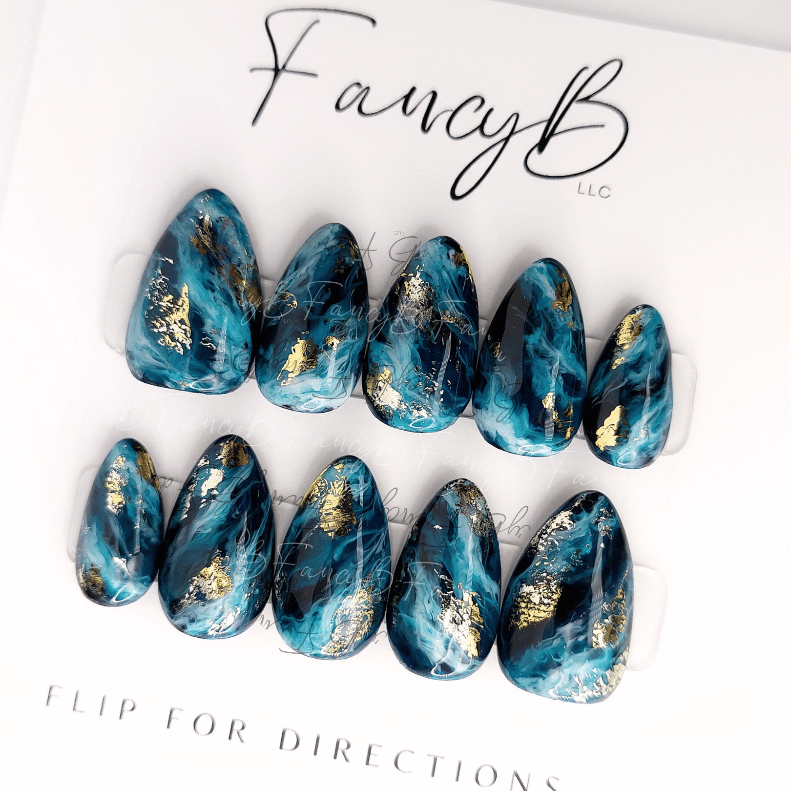 FancyB Nails custom design. Blue marble ocean nails with teal and white designs with gold flakes in short almond nail shape. Custom nail set.