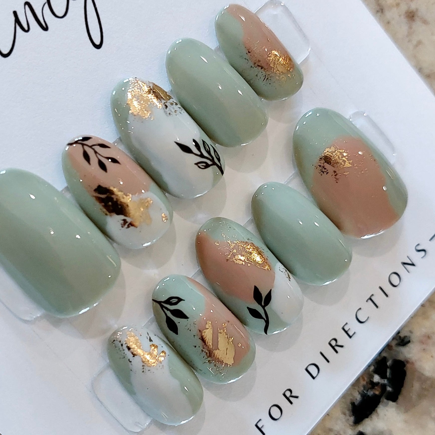 Custom press on nail set, boho leaves and gold flakes with sage and clay colors. FancyB Nails