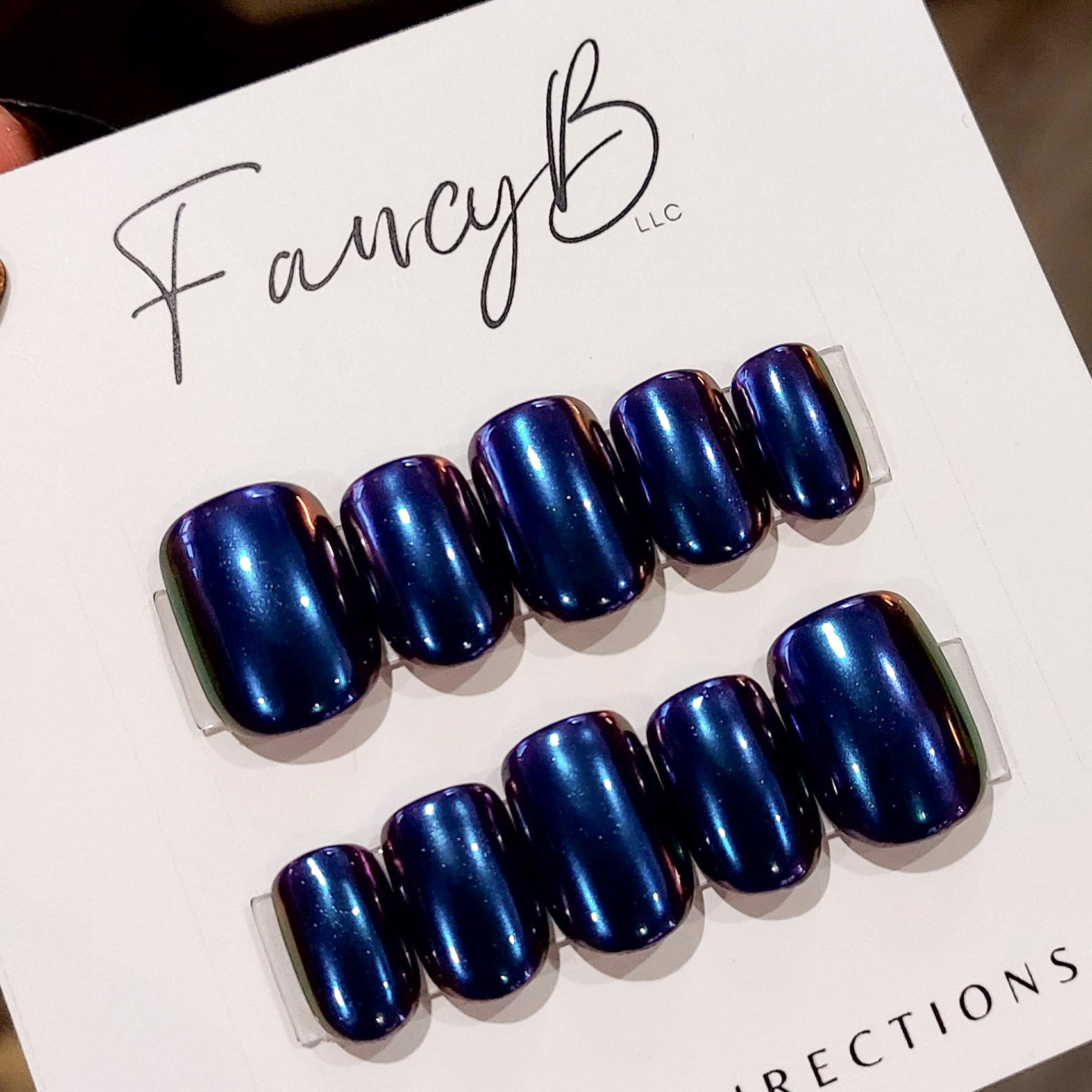 Custom chrome press on nails with purple and blue chameleon chrome on short square nails. FancyB Nails.