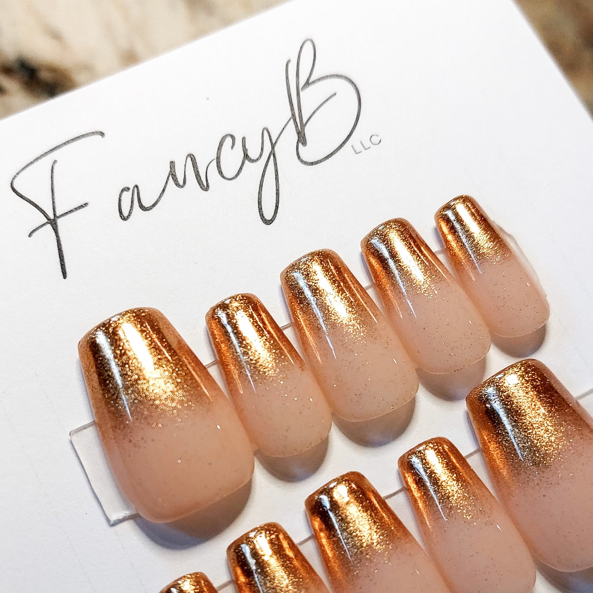 Custom press on nails with gold chrome ombre tips, nude base color and short coffin shape. Fancyb Nails.