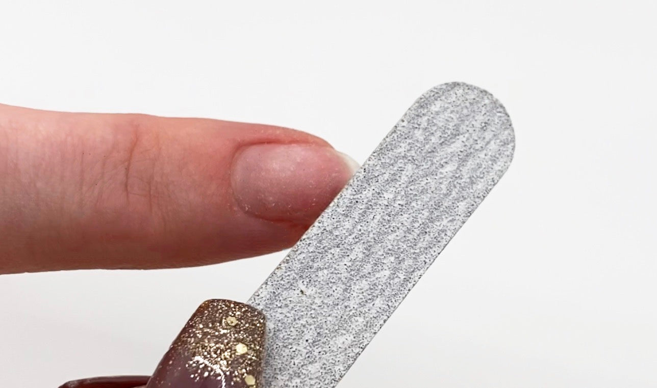 File each natural nail to scuff the surface.