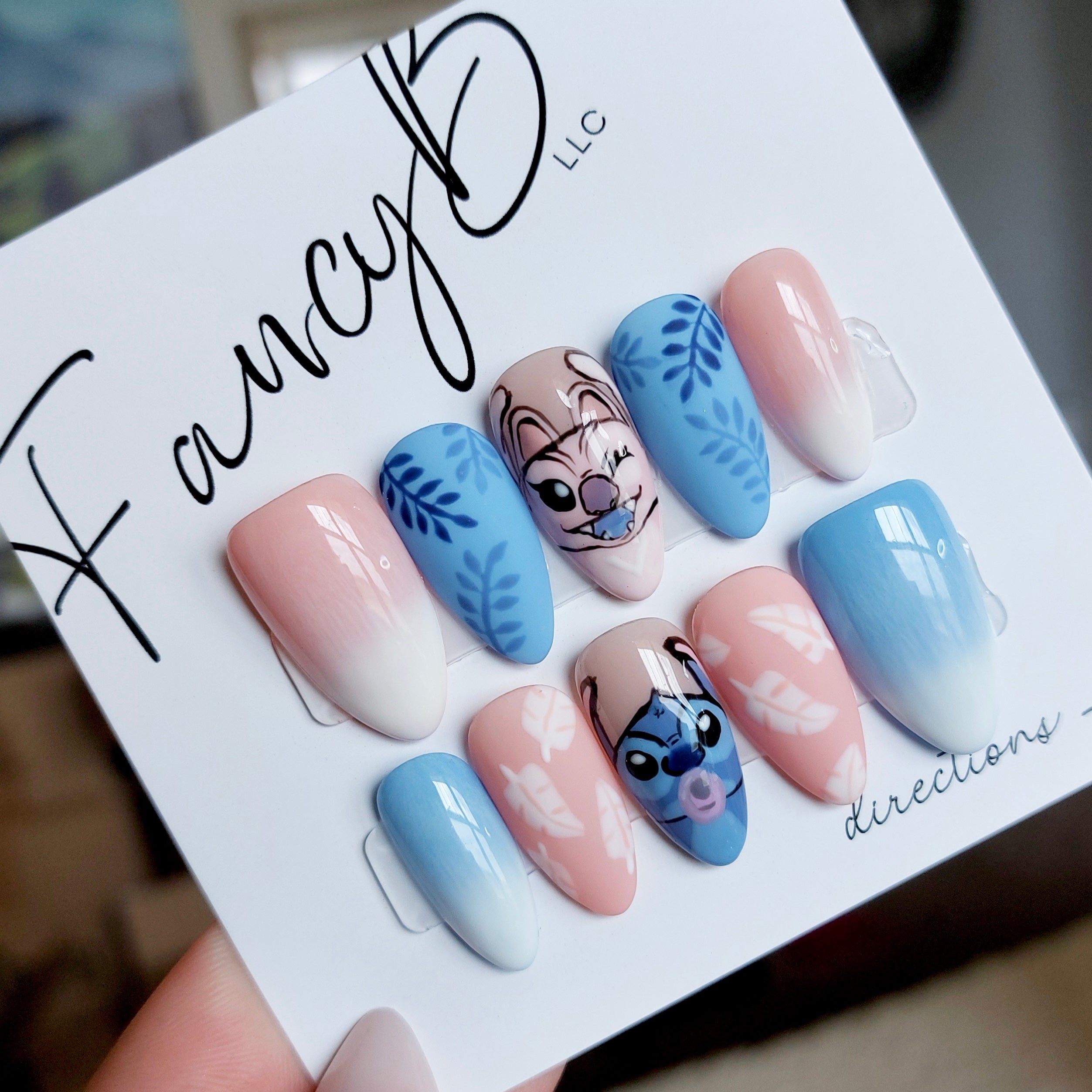 lilo and stitch press on nails, hand painted lilo and angel nails with tropical leaves, pink to white ombre, blue to white ombre and almond nails