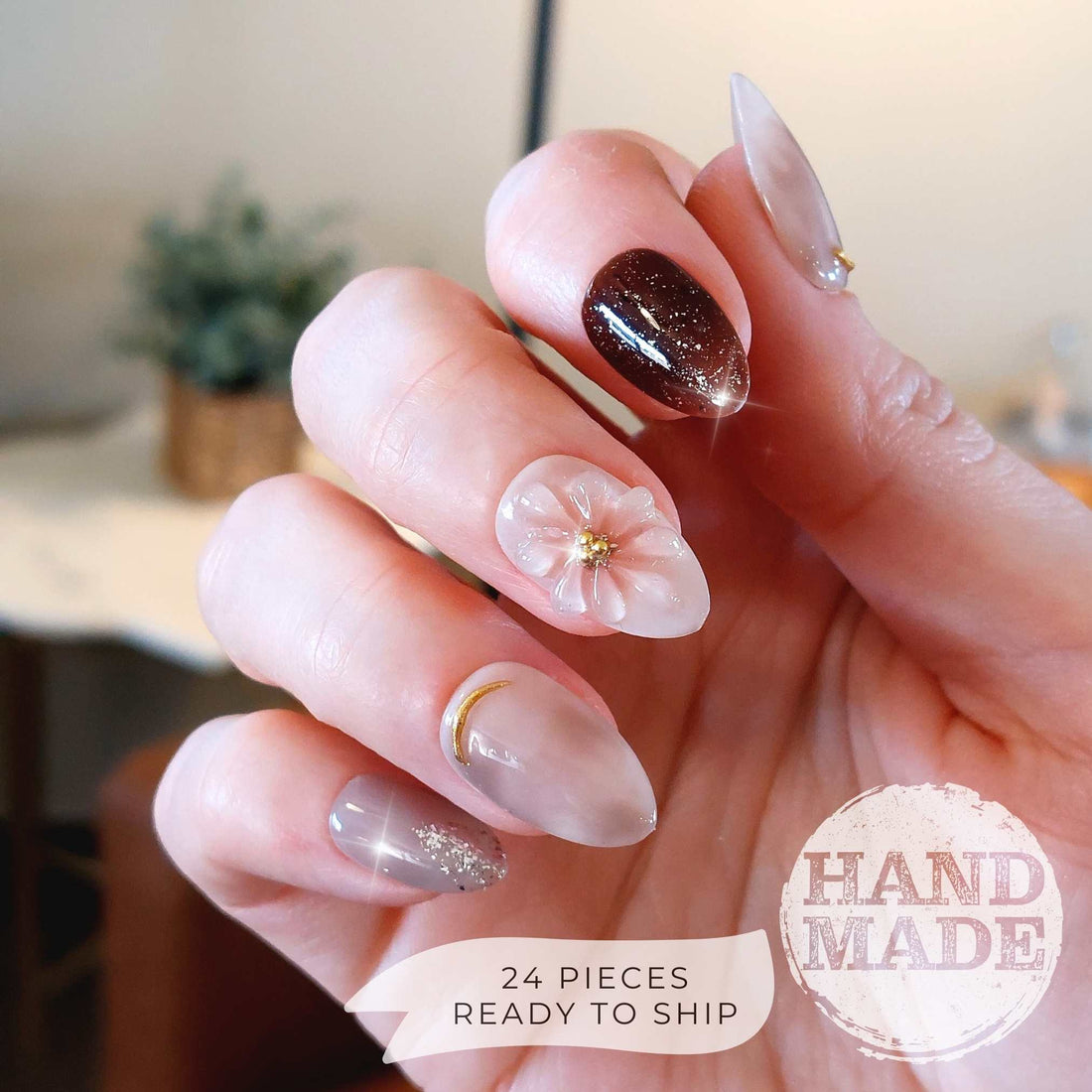 Spring floral press on nails with light pink 3d flowers, jelly gel, brown glitter accents, gold chrome details and silver glitter. Handmade press on nails from FancyB Nails show in short almond.
