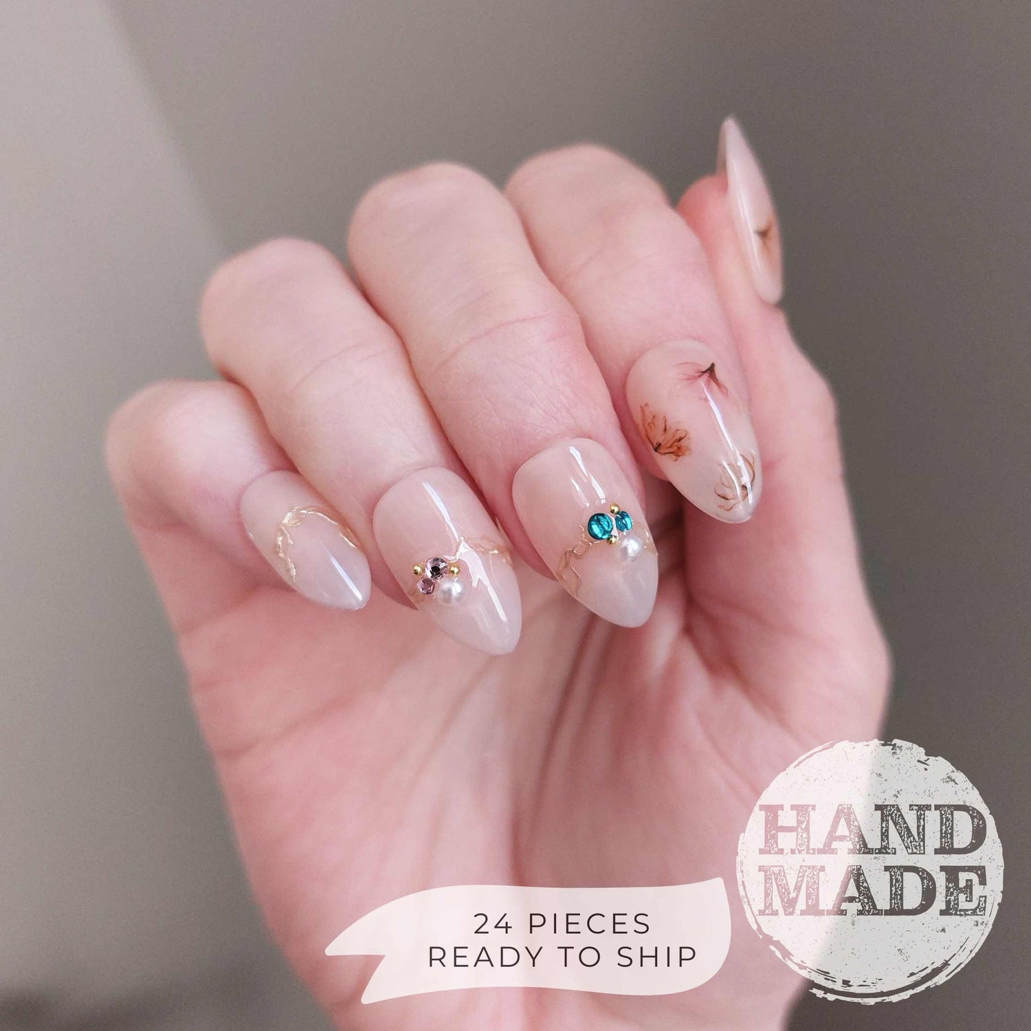 Floral press on nails, flower nails with dainty flowers, colorful gems, watercolor florals, and gold accents. FancyB handmade nails in short almond.