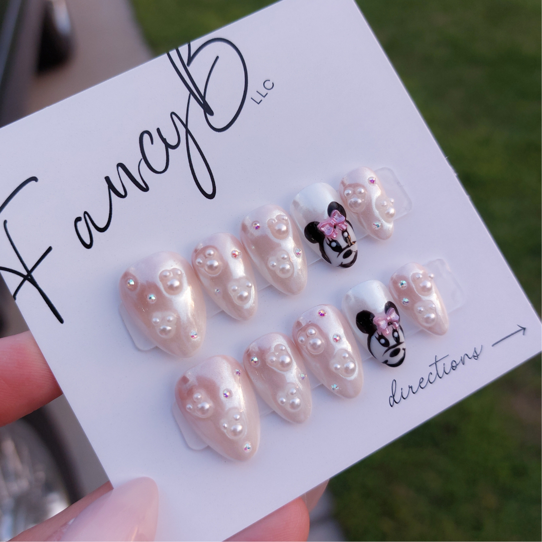 minnie mouse nails disney world theme nails with pearlescent finish and pearls from fancyb nails