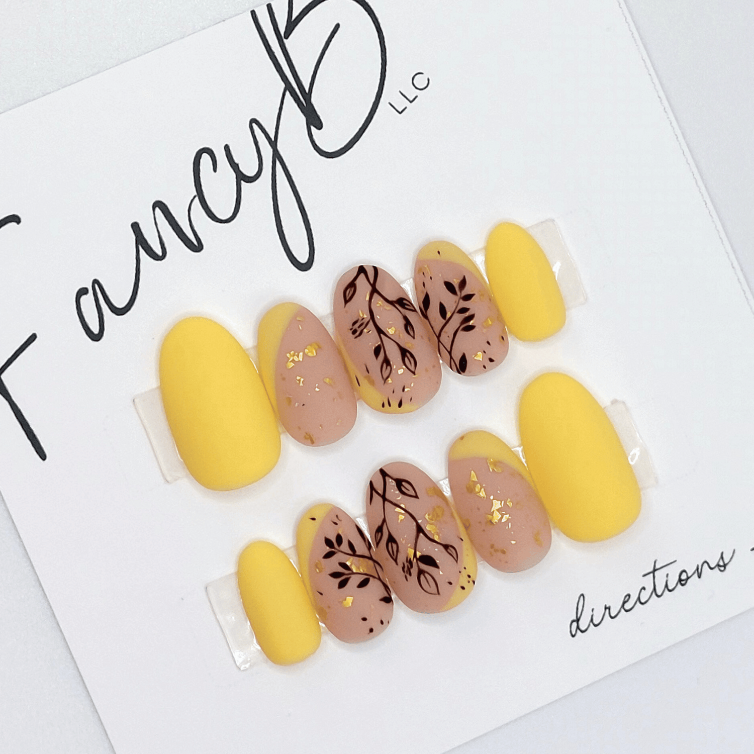 custom flower nails, floral press on nails with hand painted leaves with light soft yellow accents and gold flakes with matte finish on short oval nails.