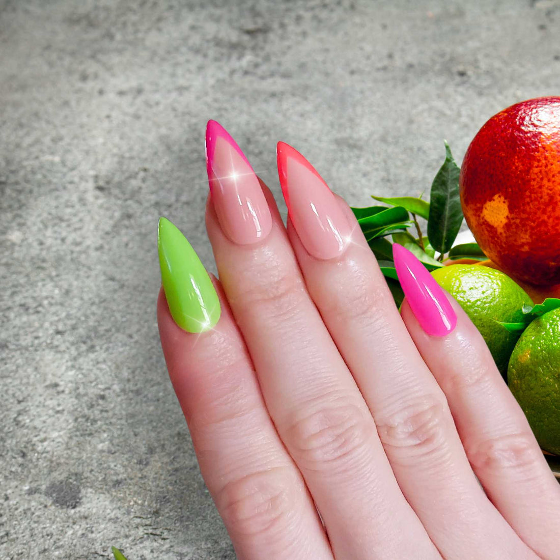 Neon nails with alternating french middle and ring, lime green, fuchsia pink, and neon coral colors on sharp stiletto fancyb luxury nails