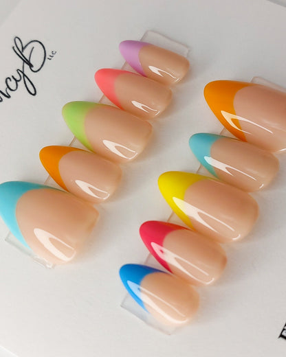 Custom colorful french tip press on nails with nude gel and multi-colored french tips. Rainbow press on french tips.
