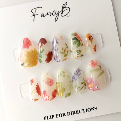 Milky Floral Press on Nail design adorned by some truly realistic flower designs in a short almond shape
