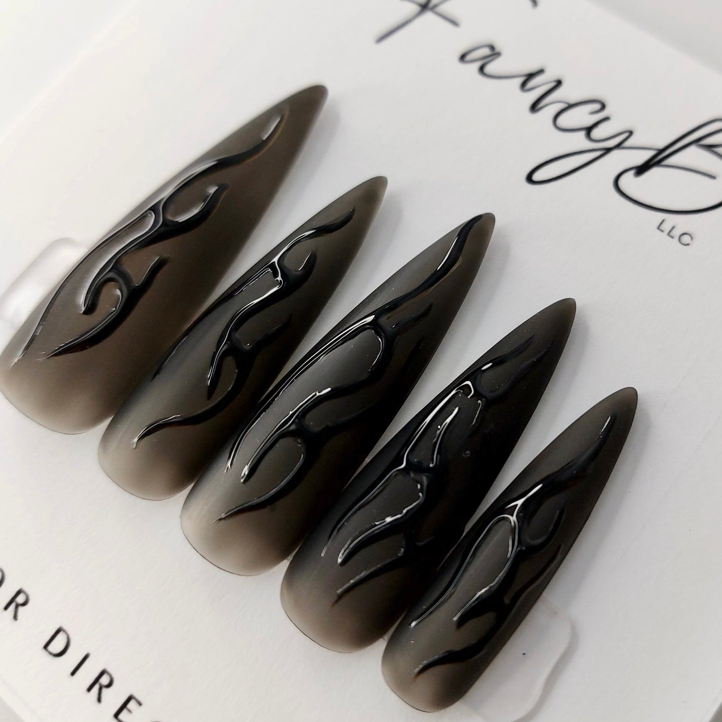 Custom press on nails, goth theme nails with matte black jelly base and gloss flame designs in extra long stiletto shape. FancyB Press on Nails.