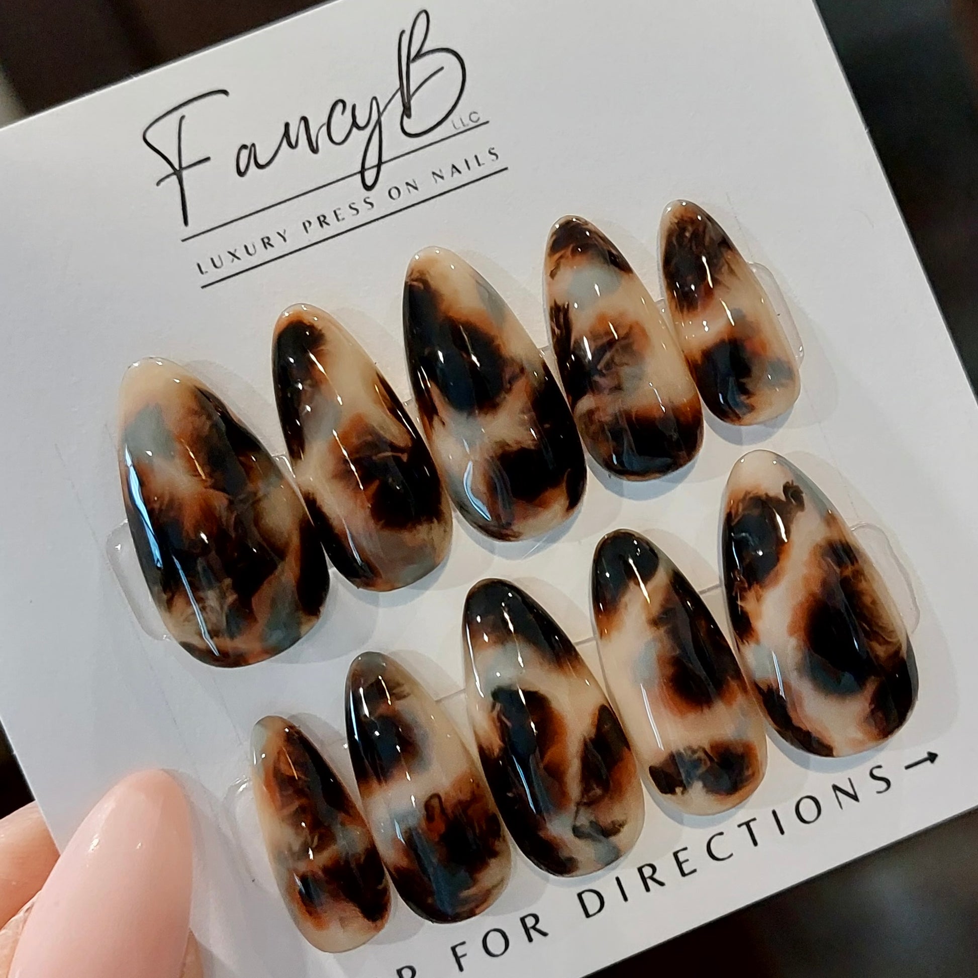 custom hand painted tortoiseshell press on nails in long almond shape. Layers of gel and high gloss finish. FancyB Luxury Nails.