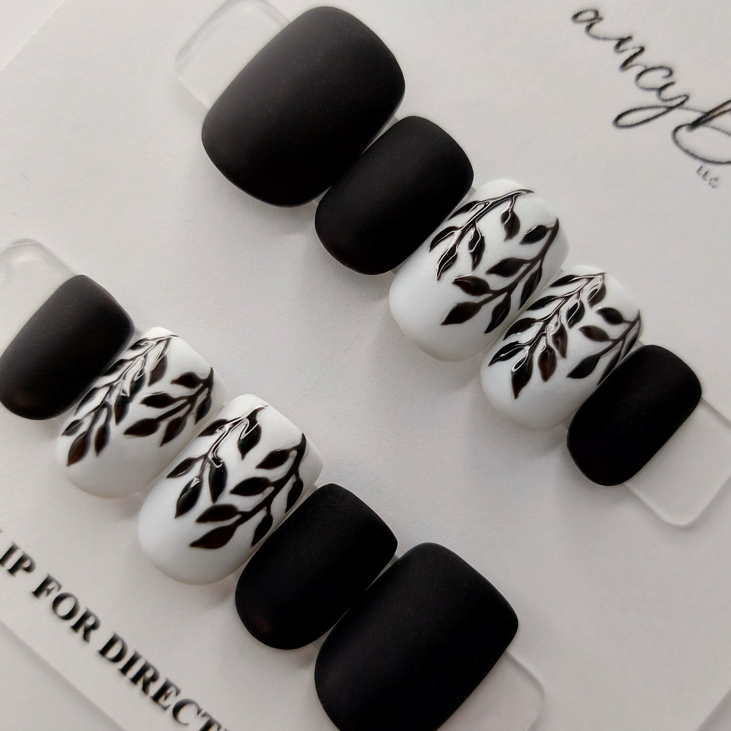 Black and white leaf nails with matte finish, a custom design that embodies elegance and simplicity, hand painted leaves finished in gloss.